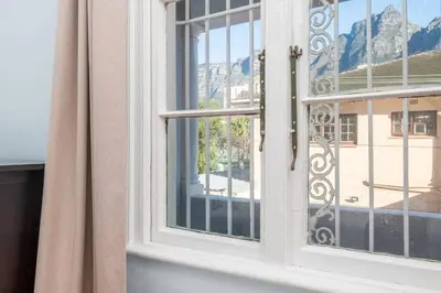 a window with a view of a mountain at Enchanting Abode in Rosebank in Cape Town