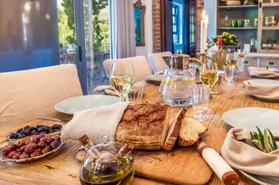 a wooden table with wine glasses and food on it at Serendipite Villa in Franschhoek