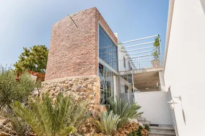 a brick building with a window and some plants at Serendipite Villa in Franschhoek