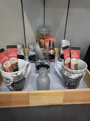 a shelf with two cups and jars of food at 9 on Oostersee in Cape Town