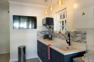 a kitchen with a sink and a counter top at Mitre's Edge Orchard Suite in Klapmuts