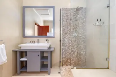 a bathroom with a sink and a shower at La Terra de Luc in Franschhoek