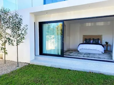 a bedroom in a house with a large window at Stellenbosch - Winelands Living Solar in Stellenbosch