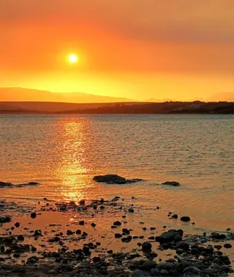 a sunset on the shore of a body of water at The 10th Hole - Golf Estate in Villiersdorp