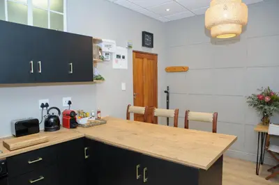 a kitchen with a wooden counter top in a room at Royal Pearl, Insta-worthy APT in Paarl