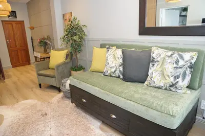 a couch with pillows on it in a living room at Royal Pearl, Insta-worthy APT in Paarl