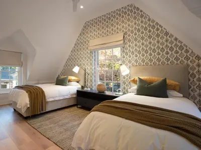 a bedroom with two beds and a window at Mount Vernon Manor in Klapmuts