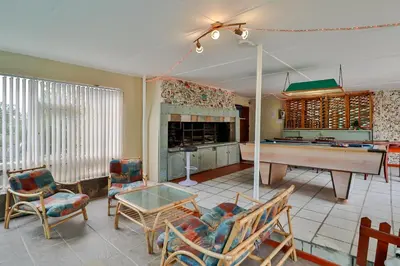 a living room with a ping pong table in it at Fisherhaven Travellers Lodge in Hermanus