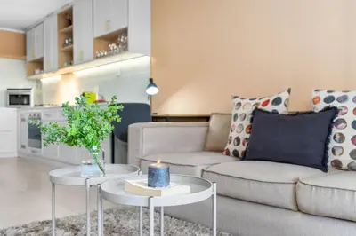a living room with a couch and a candle on a table at Mayfair Luxury 212 by Host Agents in Cape Town