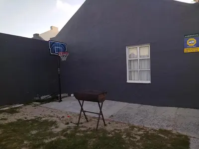 a black building with a basketball hoop and a window at Exclusive guesthouse in Cape Town
