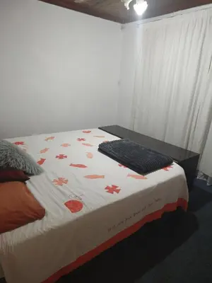 a bedroom with a bed with a keyboard on it at Exclusive guesthouse in Cape Town