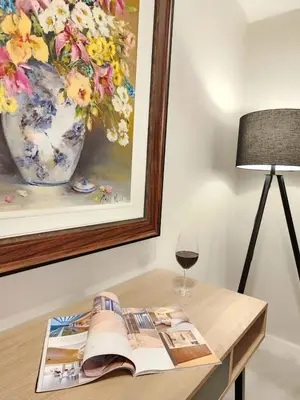 a table with a book and a glass of wine at 10 on Gillian Self-catering Apartments - NOT AFFECTED BY LOADSHEDDING in Eversdal
