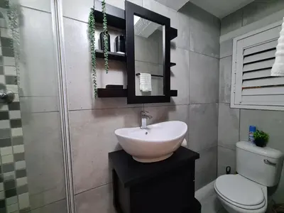 a bathroom with a sink and a toilet and a mirror at 10 on Gillian Self-catering Apartments - NOT AFFECTED BY LOADSHEDDING in Eversdal