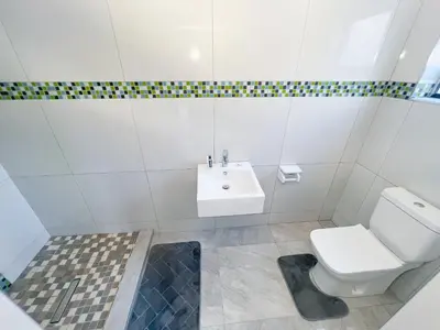 a bathroom with a toilet and a sink at BOSTON HOUSE in Cape Town