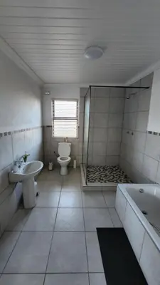 a bathroom with a tub and a toilet and a sink at Sandrivier Farm Stay in Worcester