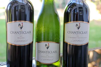 two bottles of wine sitting next to each other at L'Auberge Chanteclair in Franschhoek