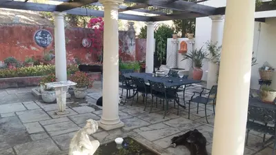 a patio with a table and chairs and a piano at Morton Manor in Somerset West