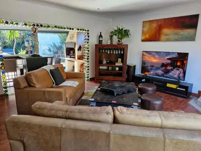 a living room with two couches and a fireplace at Spacious home in Cape Towns Blouberg area in Cape Town
