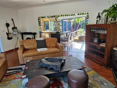 a living room with a couch and a table at Spacious home in Cape Towns Blouberg area in Cape Town