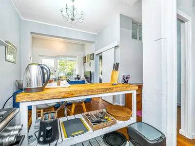 a kitchen with a counter top in a room at Cosy Victorian Style Full Apartment in Cape Town