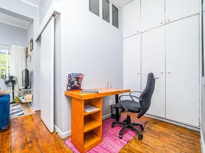a home office with a desk and a chair at Cosy Victorian Style Full Apartment in Cape Town