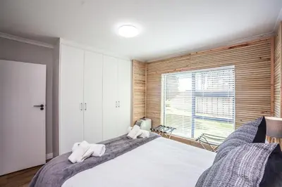 a bedroom with a large bed with towels on it at @Villa de Vie holiday apartment in Cape Town