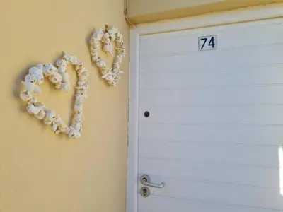a number hanging on a wall next to a door at Hermanus Beach Club UNIT 74 in Hermanus