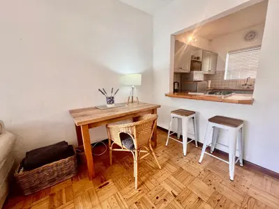 a kitchen with a table and chairs in a room at #Restyourcase in Stellenbosch