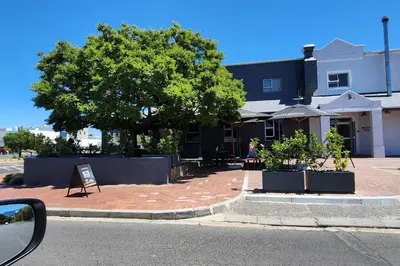 a tree and a sign in front of a building at Ebenezer in Somerset West