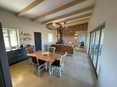 a kitchen and dining room with a wooden table and chairs at Windon vineyard farmhouse in Stellenbosch
