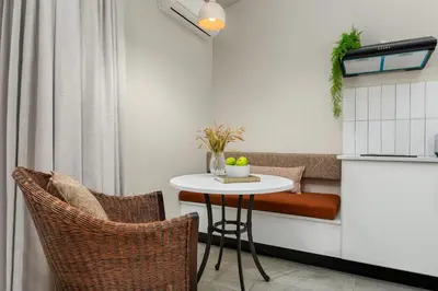 a small kitchen with a table and two chairs at Neighbourgood Franschhoek in Franschhoek