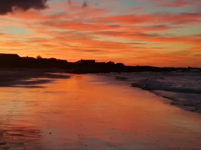 a view of the beach at sunset at Paradise Beach House in Clareport
