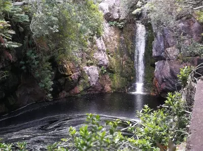 a waterfall on the side of a rocky cliff at Paradise Beach House in Clareport