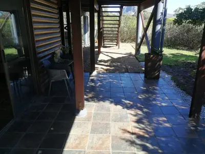 a front door of a house with a patio at Paradise Beach House in Clareport
