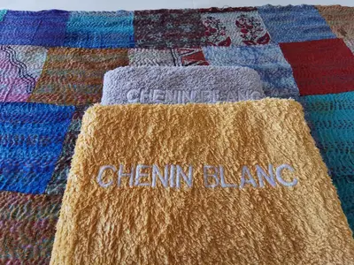 a quilt with the words cleaning cleaning sitting on a bed at Somerset Grace Double en-suit in Somerset West