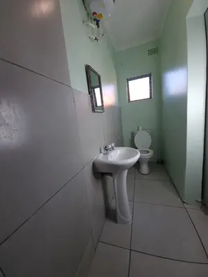 a bathroom with a sink and a toilet at Ojong's Guesthouse Kraaifontein - Eikendel in Cape Town