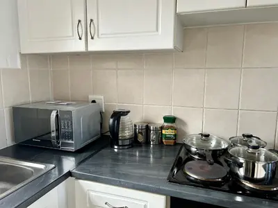 a kitchen counter top with a microwave and a stove at The Great escape 5 mins away from Blouberg Beach in Cape Town