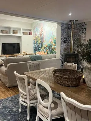 a living room with a table and chairs and a couch at 7de Hemel Paarl in Paarl