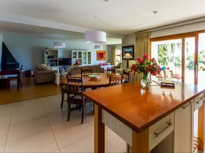 a kitchen and living room with a table and chairs at Villa Vista in Somerset West