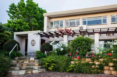 a house with flowers in front of it at Majorca House in Somerset West