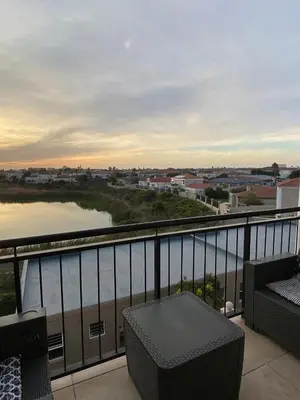 a balcony with a view of a body of water at Century On Lake Apartment in Cape Town