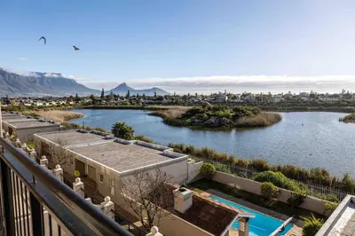 a view of a river from a balcony at Century On Lake Apartment in Cape Town