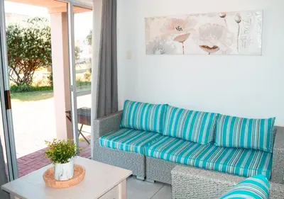a living room with a couch and a table at MarineView Getaway in Hermanus