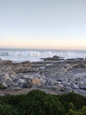a rocky beach with waves in the ocean at MarineView Getaway in Hermanus