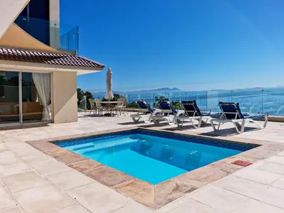 a swimming pool in a villa with a view at 'Harbour Views' - 2 bedroom, sleeps 4 with private pool and large veranda! in Gordonʼs Bay