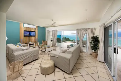 a living room with two couches and a view of the ocean at 'Harbour Views' - 2 bedroom, sleeps 4 with private pool and large veranda! in Gordonʼs Bay