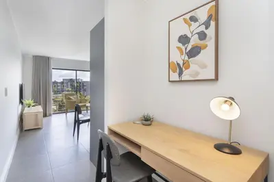 a dining room with a wooden table in a room at The Terraces 330 by Host Agents in Cape Town