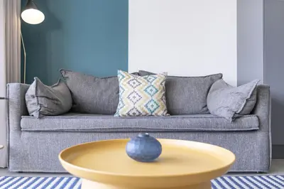 a living room with a couch and a yellow coffee table at The Terraces 330 by Host Agents in Cape Town