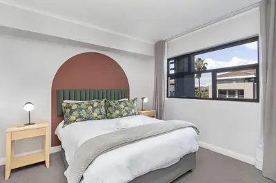 a bedroom with a large bed and a large window at The Terraces 330 by Host Agents in Cape Town