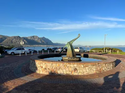 a statue of a bird sitting in a fountain at Hermanus Waterfront Apartment no 17 in Hermanus
